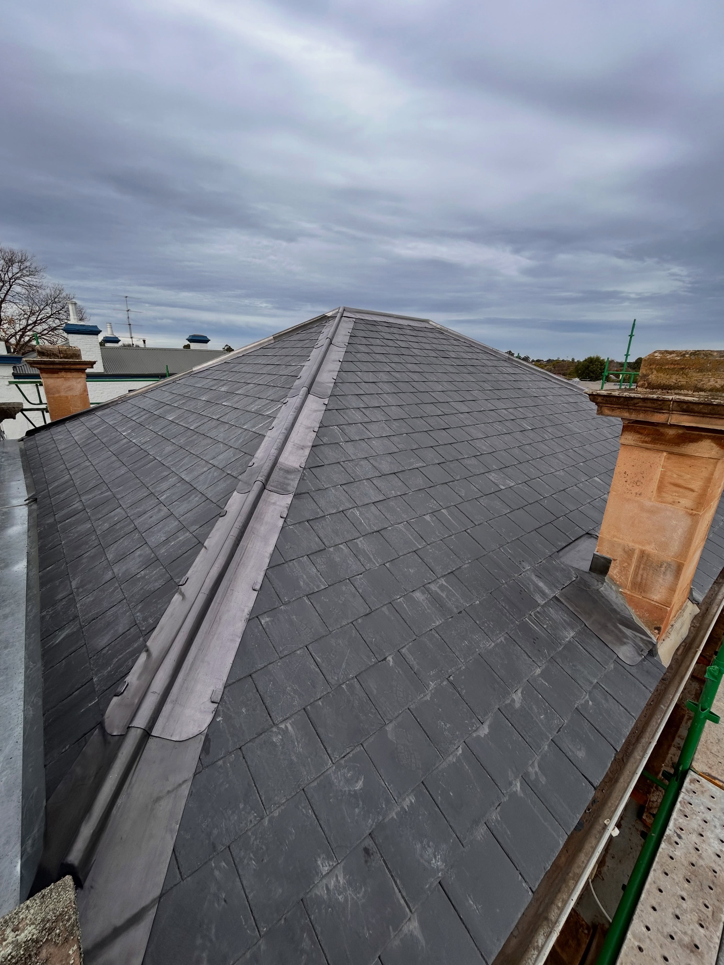 Replacing the original roof on this one which was done all the way back in 1883 🤯. Lovely doing these traditional lead roll top ridges, bringing the original look back, Canadian slates and full chimney lead work replaced. Job satisfaction. Working along side @halligan.construction 👌🏻#roofing #slate #slateroofing #leadwork #lead